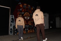 a man and a woman walking down a street at night