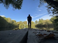 a person standing on a bridge